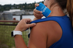 BodyGlide 1.5oz next to a phone showing compact travel-friendly size