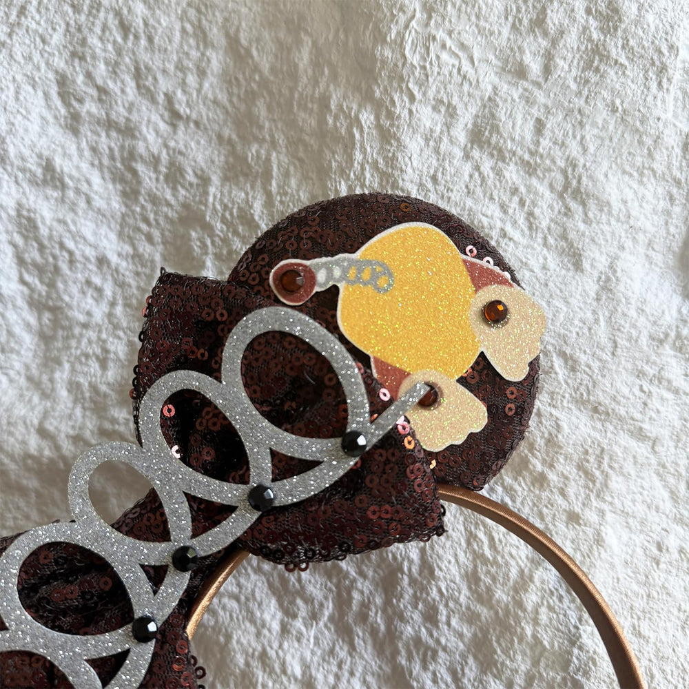 Bolonar headband beside a hand for scale demonstrating adult-friendly size