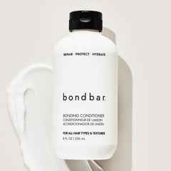 Applying Bondbar through wet hair illustrating improved detangling and manageability