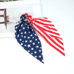 Bookay scrunchie beside coin showing compact size and portability