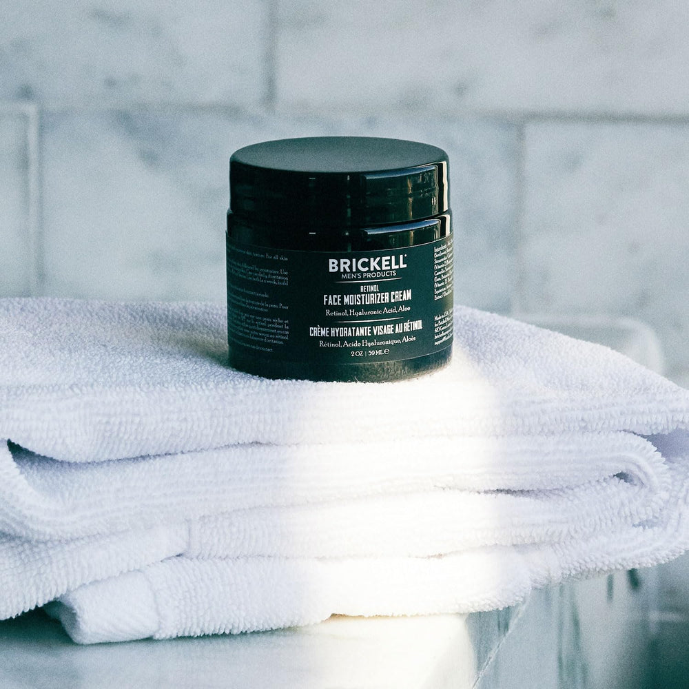 Brickell Men's Products jar on bedside table illustrating nightly skincare integration