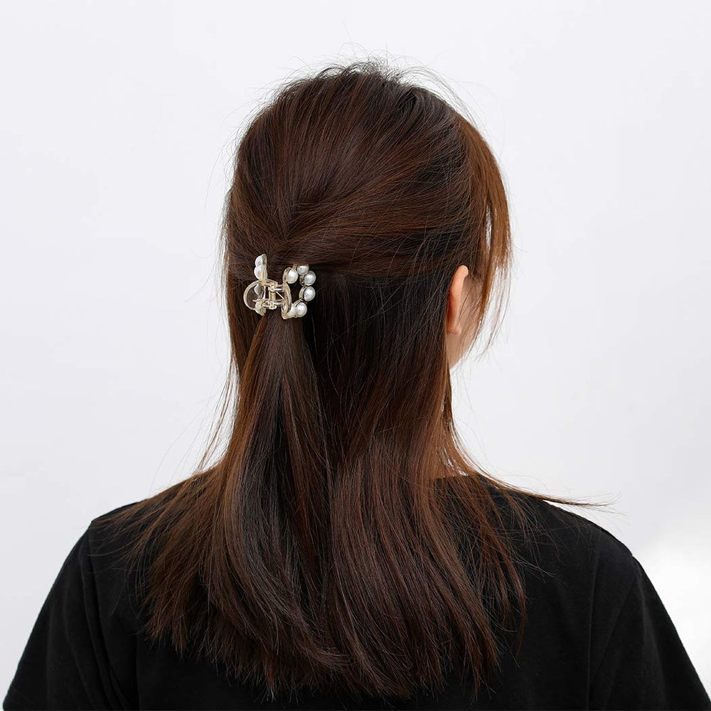 Brinie clips next to hand illustrating medium and small sizes for scale
