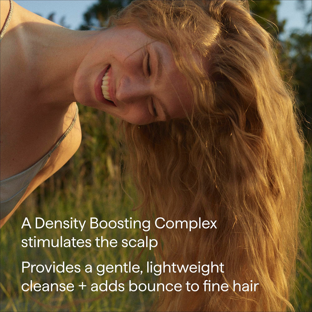 person using Briogeo shampoo in shower demonstrating scalp massage benefit