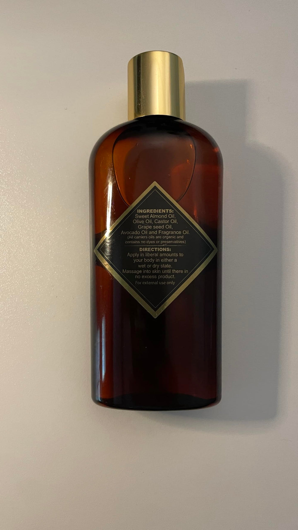 Brown Sugar Babe bottle next to hand showing scale and travel-friendly size benefit