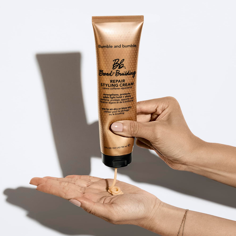 Bumble and bumble tube next to hand illustrating compact 5 fl oz travel-friendly size