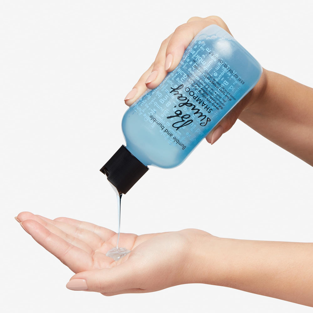 Bumble and bumble bottle in hand showing 8.5 fl oz size and practical scale