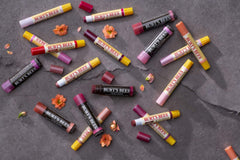 Burt's Bees swatches on skin showing sheer lilac tint and natural shine