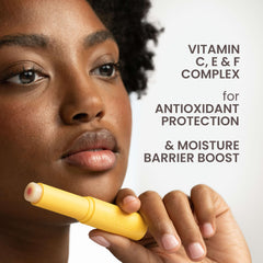 Burt's Bees tube held in hand to show size and travel-friendly convenience