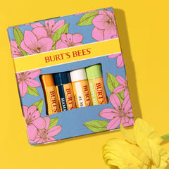 Burt's Bees tube in hand to show compact 0.15 oz size and travel convenience