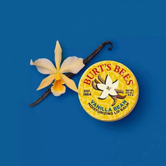 Hand holding Burt's Bees vanilla bean tin to show size and pocket-friendly benefit