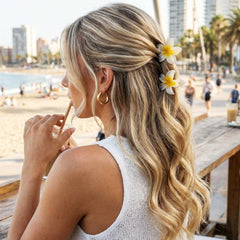 CAKURE plumeria clip worn in hair styling showing decorative tropical accent benefits