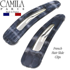 Camila Paris clip held in hand showing compact 2-inch size for travel