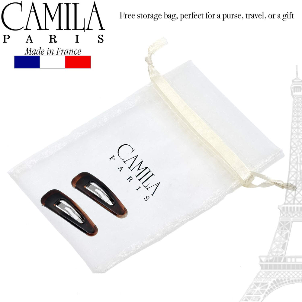 Camila Paris clip beside hand for scale showing compact 2.5-inch size