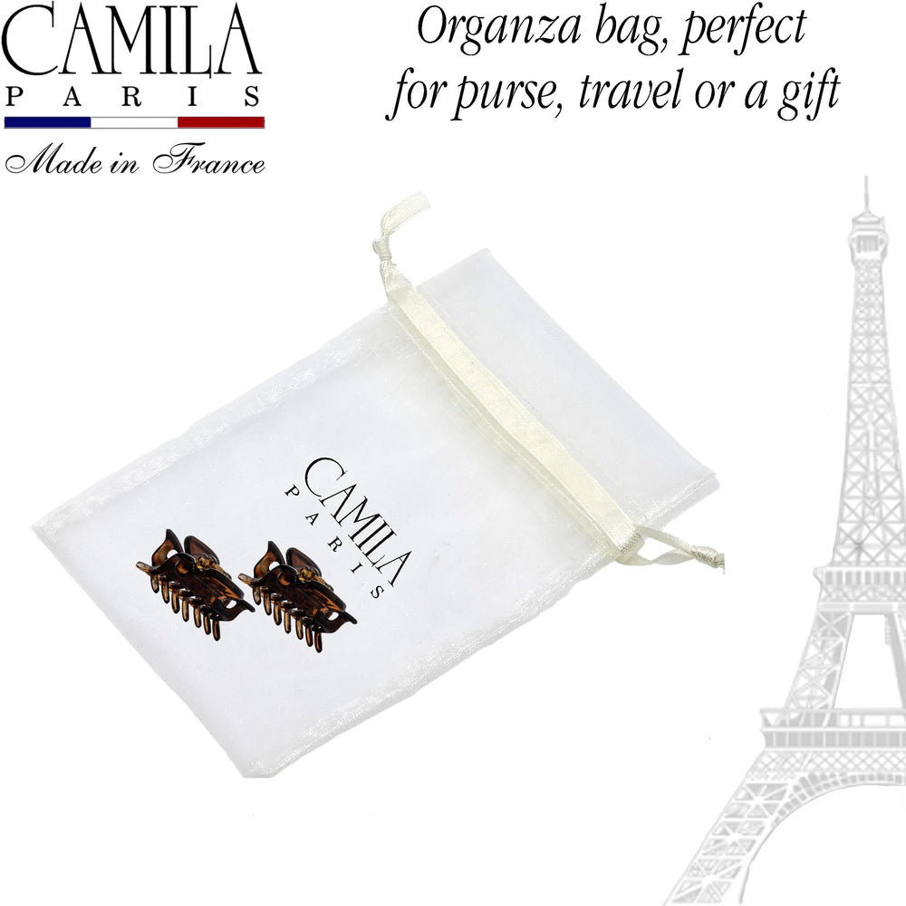 Camila Paris clips held between fingers to show compact 1.5 inch scale benefit