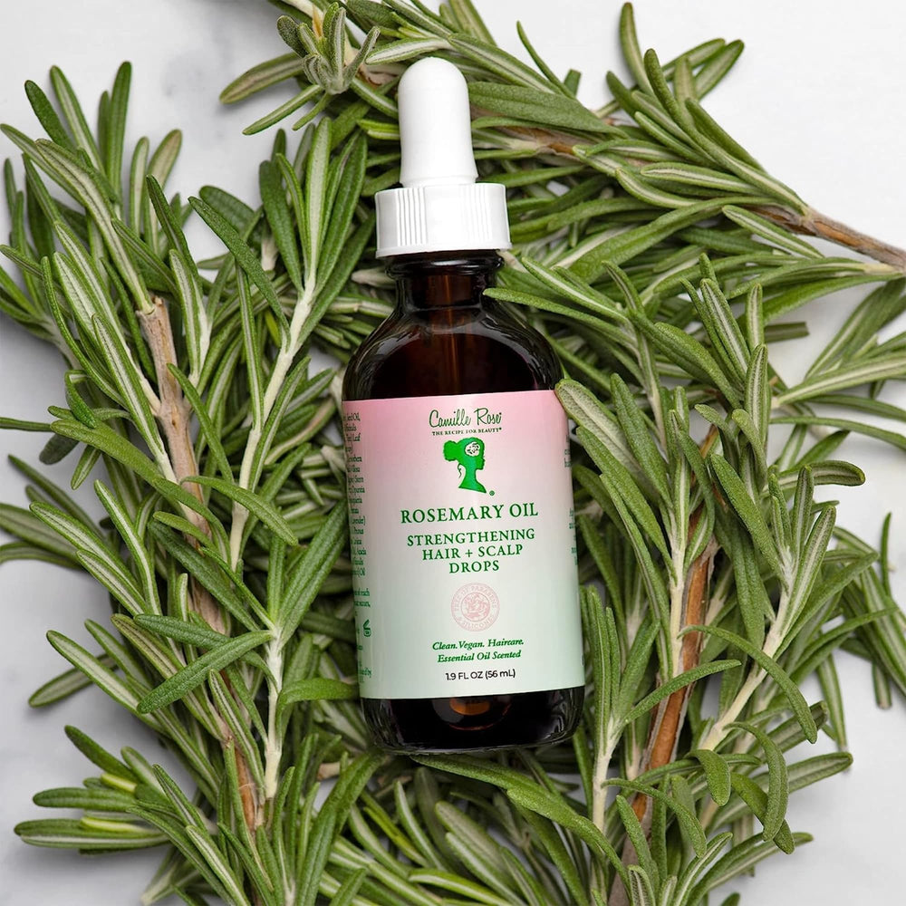 Camille Rose smoothing oil through hair lengths to reduce frizz and breakage