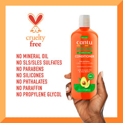 Cantu conditioner applied to wet curly hair in shower demonstrating detangling benefit