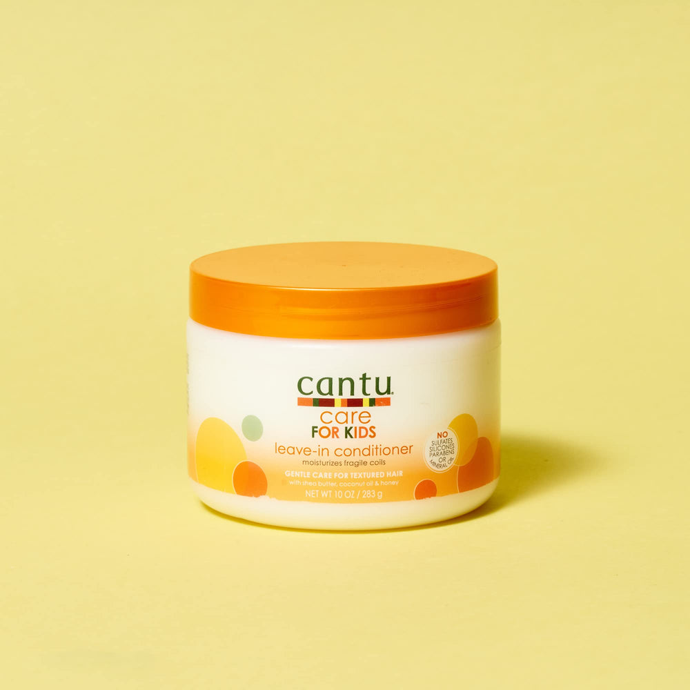Child having hair detangled with Cantu leave-in conditioner for gentler comb-through