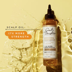 Carol's Daughter applying oil to scalp to relieve dryness and nourish