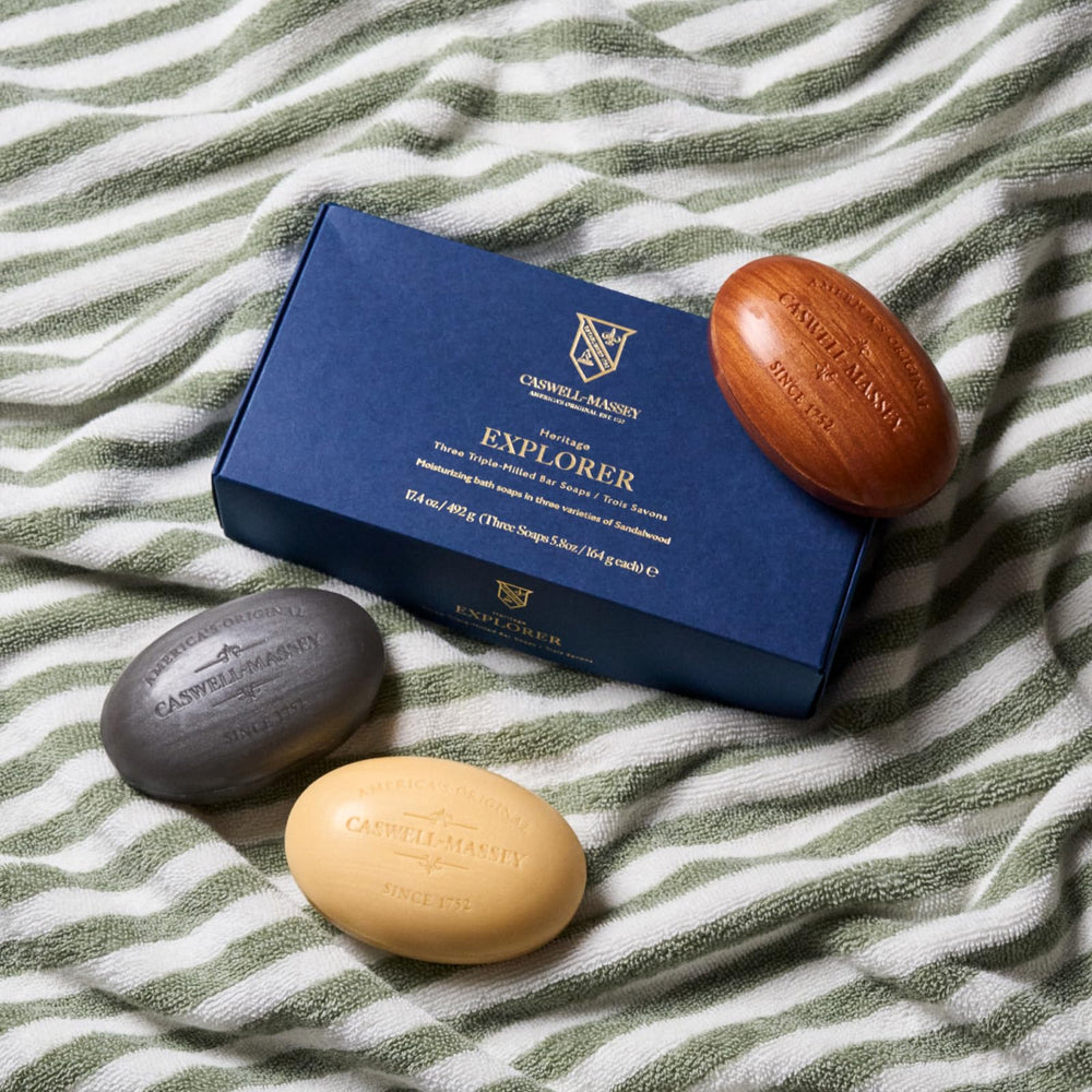 Caswell-Massey bar held in hand showing 5.8 oz size and travel convenience