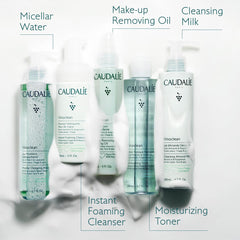 Caudalie bottle with almonds and grape seeds highlighting nourishing ingredients