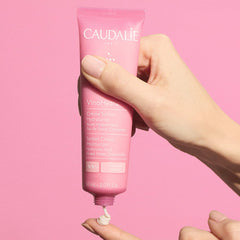 Caudalie jar next to credit card showing compact 60 mL travel-friendly size