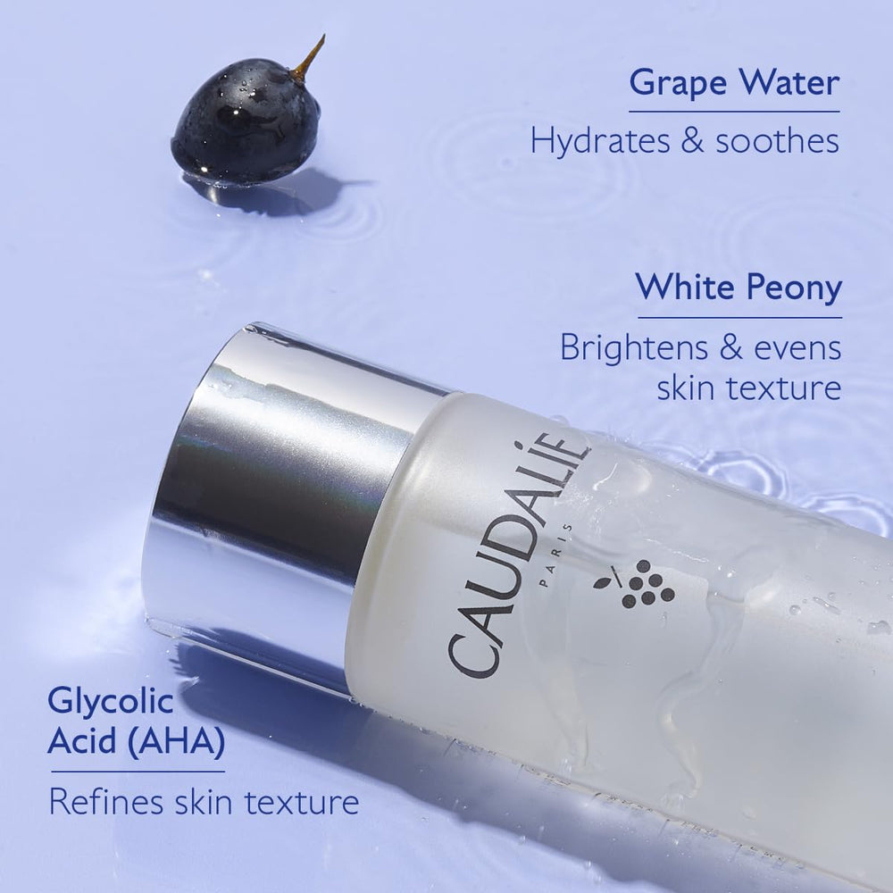 Applying Caudalie essence with cotton pad demonstrating gentle exfoliation