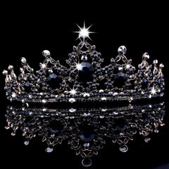 CAVETEE crown held by hand for scale showing compact wearable size
