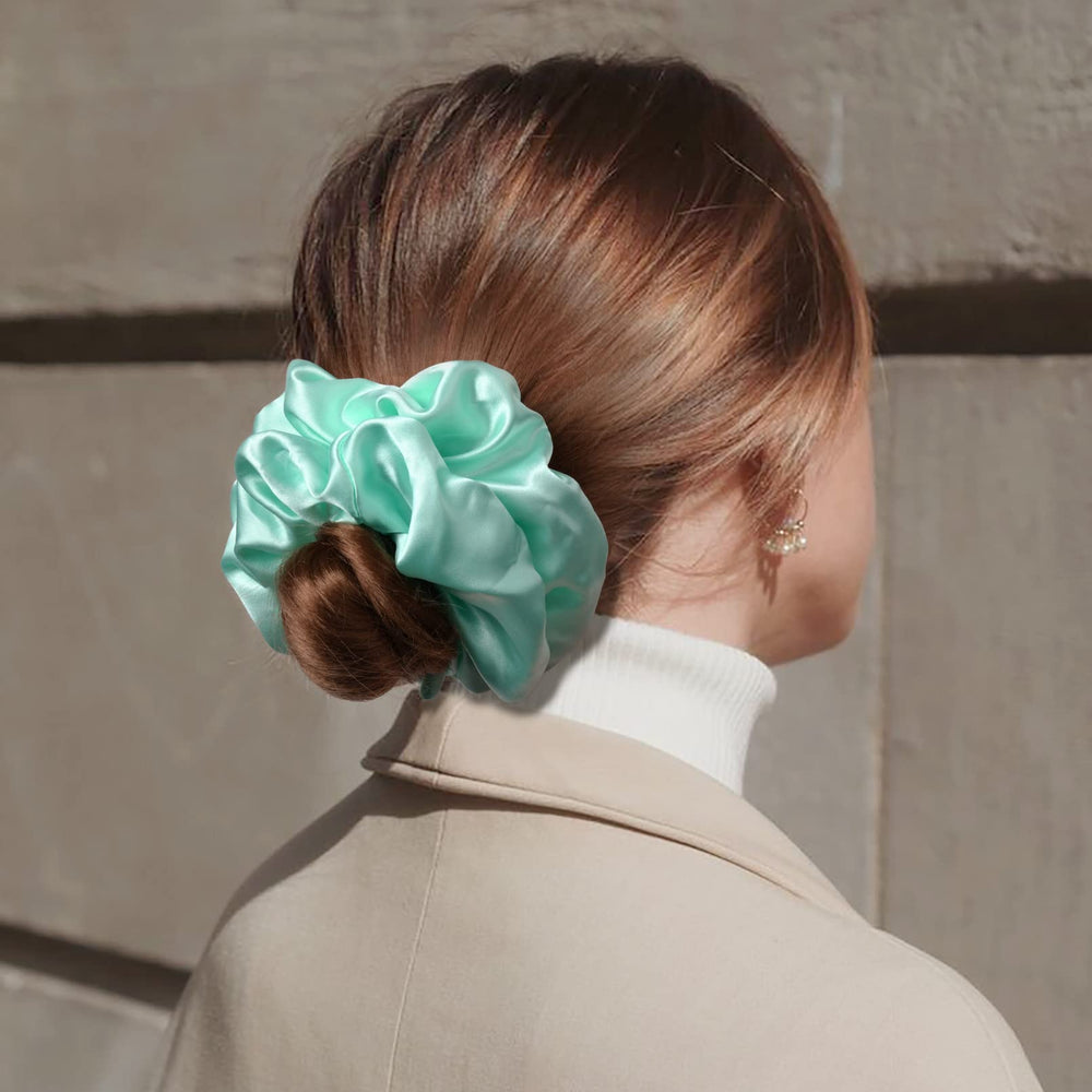 CEELGON scrunchie shown in hand to illustrate large 6.5-inch scale and coverage