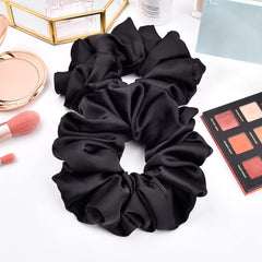 CEELGON six-pack flat lay showing matching black jumbo scrunchies