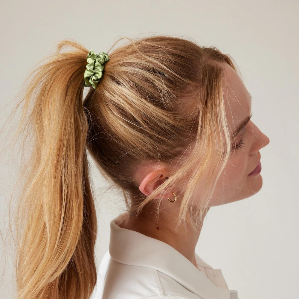 CEELGON scrunchie held in hand for scale showing compact size and gentle hold