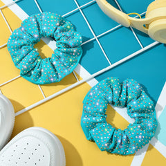 CEELGON scrunchie under stage lighting emphasizing multicolor sparkle effect