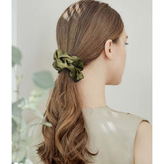 Cehomi scrunchie next to ruler showing size and stretch for most hair types