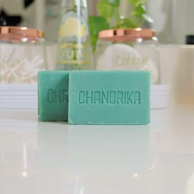 Chandrika bar in hand for scale demonstrating compact travel size and portability benefit
