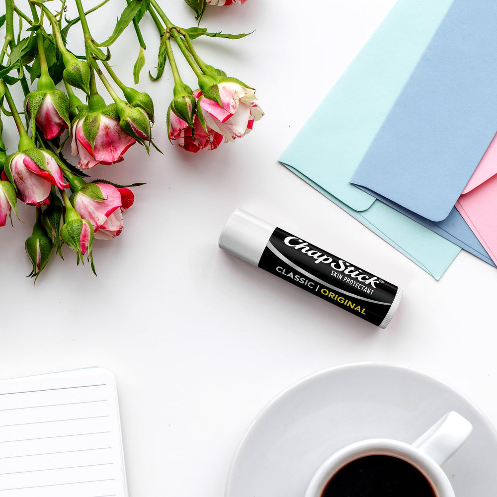 Applying ChapStick classic in hand to show quick lip moisture boost