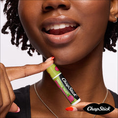 Hand holding ChapStick pack demonstrating portability and on-the-go convenience