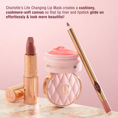 Charlotte Tilbury jar next to fingertip to show compact travel-friendly size
