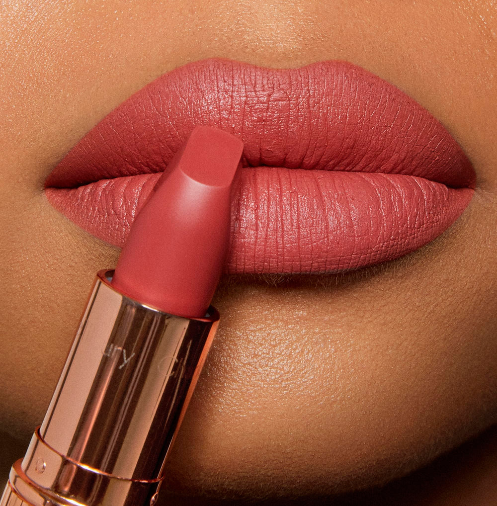 Charlotte Tilbury Sexy Sienna worn on lips in studio, enhancing natural fullness benefit