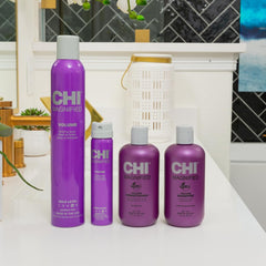CHI 12 oz conditioner next to a hand for scale shows travel-friendly size
