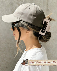 CHLINS clip threaded through trucker hat snap holding hair securely during wear