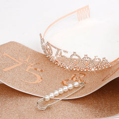 CIEHER sash and crown next to a ruler for size and scale reference