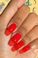 Hand model wearing Lucky Jelly swatch showing buildable sheer red depth