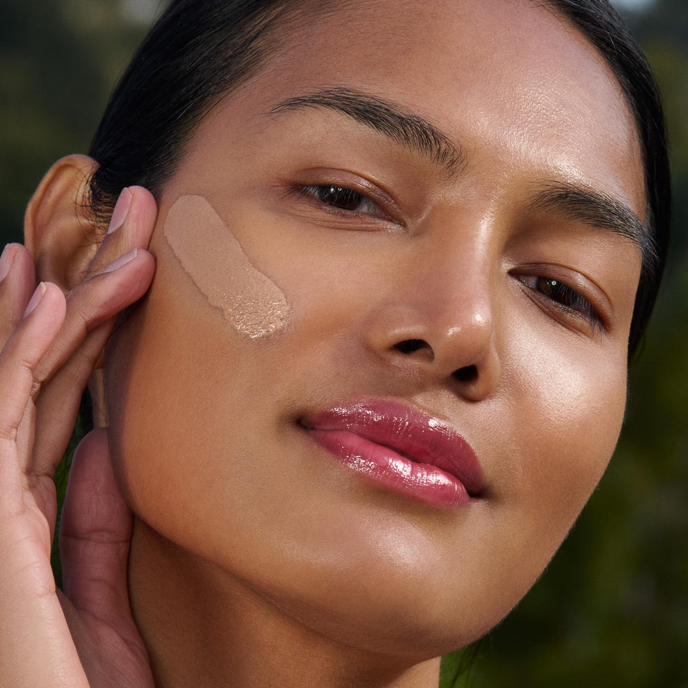 Clarins UV Plus applied on model showing natural finish and pollution defense benefit