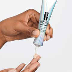 Clinique primer beside a hand for scale showing travel-ready one ounce convenience benefit