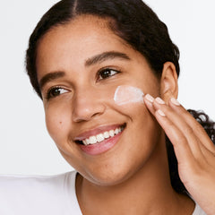Clinique scrub on hand being applied showing lightweight rinse-off benefit