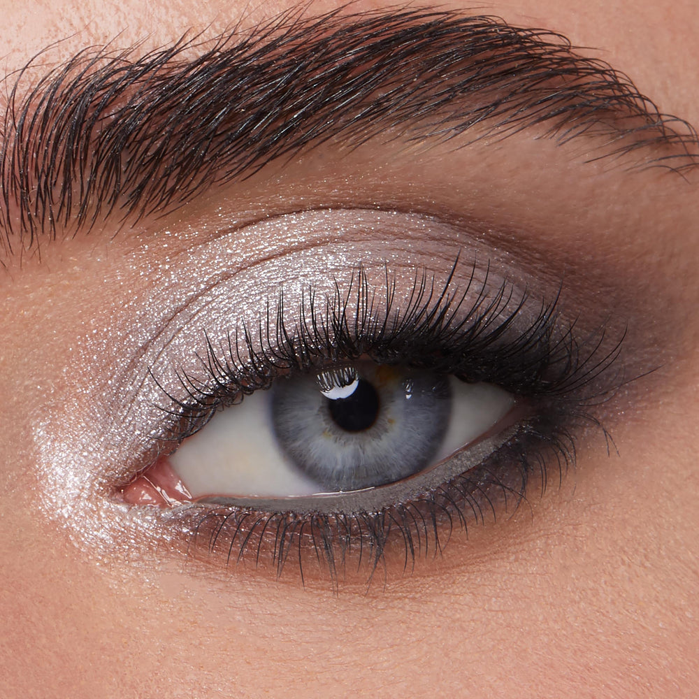 ColourPop shadow being applied with a flat brush showing intense metallic payoff and precise placement