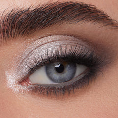 ColourPop shadow being applied with a flat brush showing intense metallic payoff and precise placement