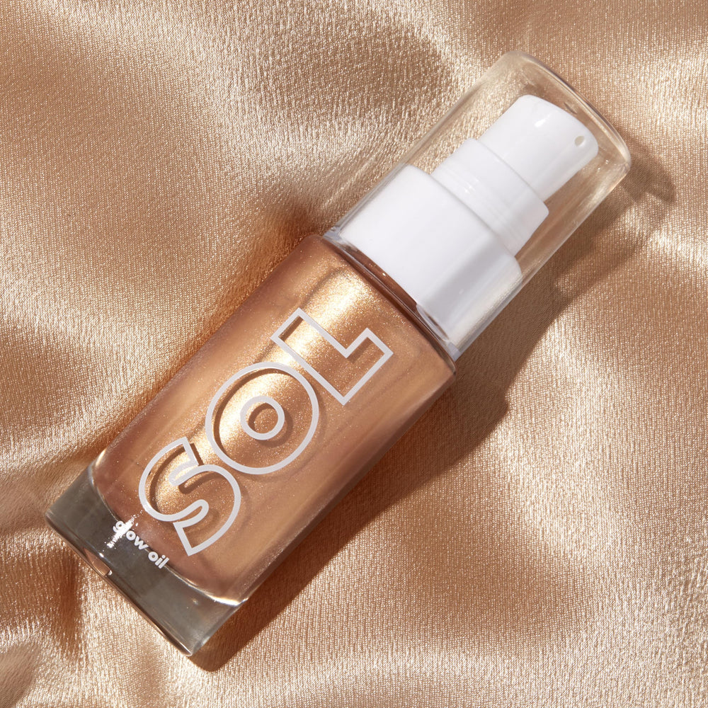 ColourPop mini glow oil applied to shoulder highlighting skin texture and hydrated radiant finish