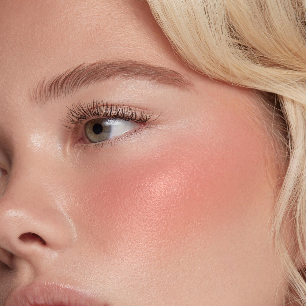 ColourPop Super Shy swatch on skin illustrating sheer, buildable rosy glow