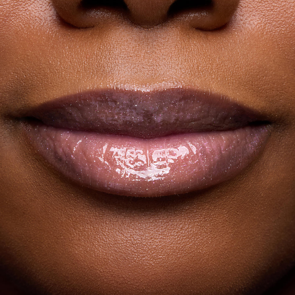 ColourPop swatch on arm showing sheer rosy tint and luminous shine benefit