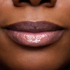 ColourPop swatch on arm showing sheer rosy tint and luminous shine benefit